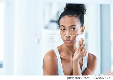 Skin care, black woman with cotton wipe on face and makeup cleaning with luxury cosmetic product in bathroom. Dermatology, cosmetics and beauty facial, African model with cleansing pad and mock up. Skin care, black woman with cotton wipe on face and makeup cleaning with luxury cosmetic product in bathroom. Dermatology, cosmetics and beauty facial, African model with cleansing pad and mock up. 132007673