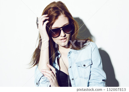 Sunglasses, fashion or woman with a denim jacket isolated on a white background in studio in USA. Confident, stylish modern girl or cool female model with trendy swag, empowerment or confidence Sunglasses, fashion or woman with a denim jacket isolated on a white background in studio in USA. Confident, stylish modern girl or cool female model with trendy swag, empowerment or confidence 132007813
