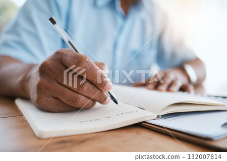 Man, hands and writing in book for finance, budget or schedule planning in remote work at home. Closeup hand of male freelancer taking notes in diary for financial record, expenses or tasks on desk 132007814