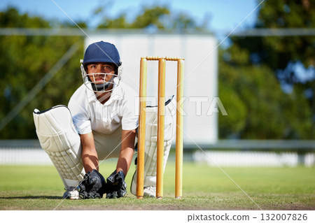 Cricket, sports and a man as wicket keeper on a pitch for training, game or competition. Male athlete behind stumps with gear for action, playing professional sport and exercise for fitness or mockup 132007826