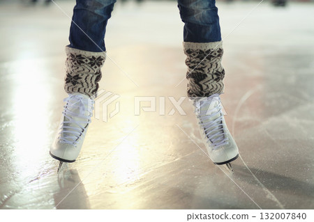 Ice skates, woman shoes and legs of skater training, recreation and skate on frozen floor, arena or stadium. Winter, entertainment and feet of female person balance, active or learning figure skating Ice skates, woman shoes and legs of skater training, recreation and skate on frozen floor, arena or stadium. Winter, entertainment and feet of female person balance, active or learning figure skating 132007840