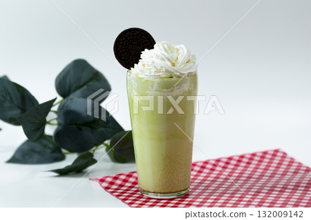 Matcha Frappuccino topped with cookies and whipped cream Matcha Frappuccino topped with cookies and whipped cream 132009142