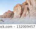 Unique rock formations rise majestically in the Sinai Desert of Egypt, illuminated by the soft glow of the setting sun, revealing stunning geology. 132009457