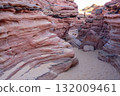 Visitors experience the stunning colors and textures of Tsvetnoy Canyon while exploring this remarkable geological site in Egypt. 132009461