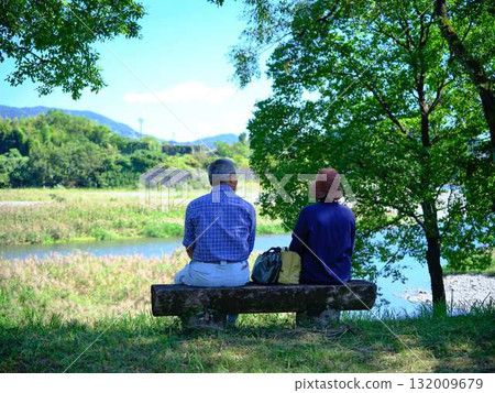 Sitting on a bench in old age 132009679