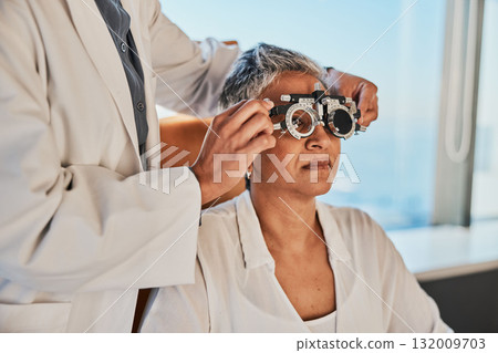Senior eye exam, optometrist and medical eyes test of elderly woman at doctor consultation. Vision, healthcare focus and old female patient with consulting wellness expert for lens and glasses check Senior eye exam, optometrist and medical eyes test of elderly woman at doctor consultation. Vision, healthcare focus and old female patient with consulting wellness expert for lens and glasses check 132009703