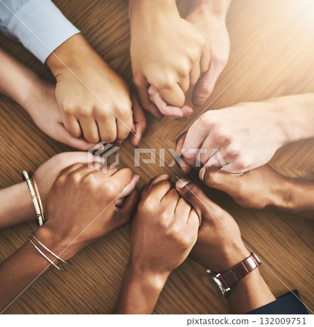 Community, trust and friends holding hands by table at group counseling or therapy session. Gratitude, love and top view of people in circle for praying together for religion, community and connect. 132009751