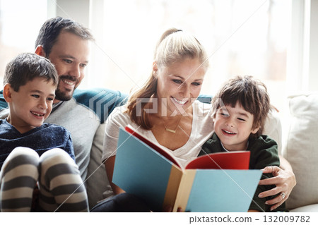 Family, reading book together with parents and children, happiness at home with story time and learning. Love, relationship and happy people bonding in living room, education and mom, dad with kids 132009782