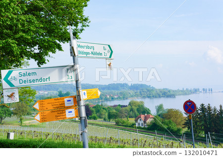 A beautiful natural scene with a sign sticking diagonally into the ground 132010471
