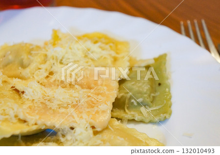 Ravioli topped with shredded cheese Ravioli topped with shredded cheese 132010493