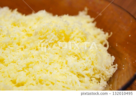 A generous pile of freshly shaved cheese 132010495