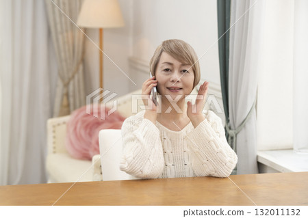 Senior women happily chatting and searching on their smartphones 132011132
