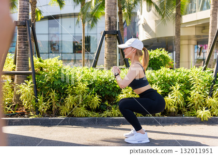 Woman does sport workout exercise outdoor fit needing to stretch muscles and stretch body for peak physical wellness and active lifestyle pursuit. 132011951