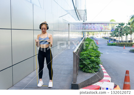 Exercise woman performs sport workout for fit body, people enjoy outdoor stretch with resistance band, training promotes healthy lifestyle, encourages regular exercise routine. Exercise woman performs sport workout for fit body, people enjoy outdoor stretch with resistance band, training promotes healthy lifestyle, encourages regular exercise routine. 132012072