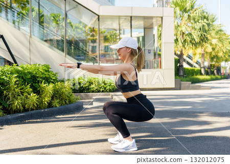 Fit woman performs sport exercise, outdoor workout for active people, stretch routine promotes healthy lifestyle, building strength with full body stretch, great for fitness in urban setting. Fit woman performs sport exercise, outdoor workout for active people, stretch routine promotes healthy lifestyle, building strength with full body stretch, great for fitness in urban setting. 132012075