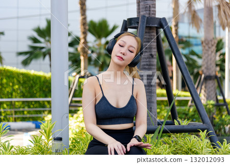 Sport woman finds refreshing outdoor workout moment, fit people enjoy relaxing exercise, listening to music after a great sport session, promoting complete wellbeing. 132012093