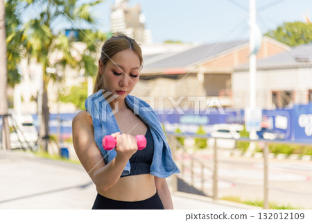 Exercise woman performs strength workout, fit people embrace outdoor sport activity, building muscle with regular exercise regimen, promoting healthy active lifestyle. 132012109