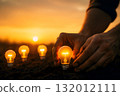 Close-up of hand planting a fluorescent light bulb in soil. Empty space above to place as headline. Concept of knowledge as the seed of success. 132012111