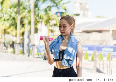 Sport woman outdoor workout, focused on fitness exercise with dumbbell, engaging body to stretch muscles for strength, preparing to stretch for improved flexibility. Sport woman outdoor workout, focused on fitness exercise with dumbbell, engaging body to stretch muscles for strength, preparing to stretch for improved flexibility. 132012133