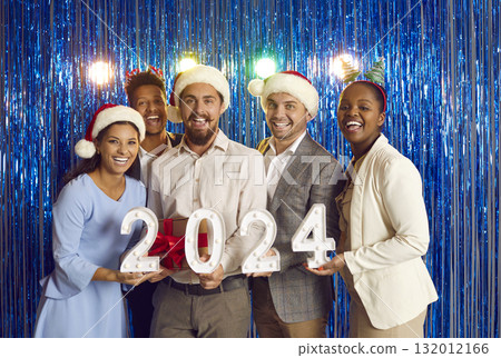 Portrait of cheerful young multiracial friends having fun together at 2024 New Year party. 132012166