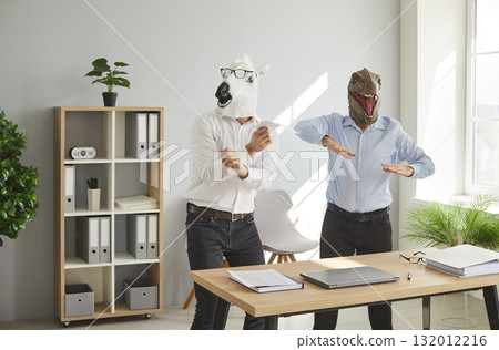 Crazy, funny office workers in horse and dinosaur masks having party at end of work day 132012216