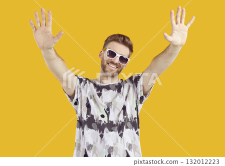 Handsome man raising his hands with open palms doing welcome gesture Handsome man raising his hands with open palms doing welcome gesture 132012223