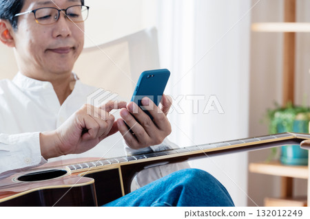 Male man who operates a smartphone 132012249