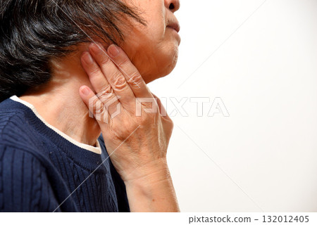 Senior woman concerned about her neck Senior woman concerned about her neck 132012405