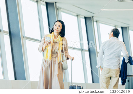 Business woman operating a smartphone 132012629
