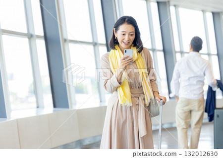 Business woman operating a smartphone 132012630