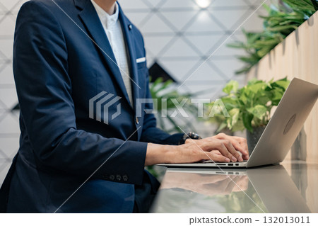 Close up, Businessman hand typing on laptop computer keyboard. surfing the internet, online working. corporate business concept. 132013011