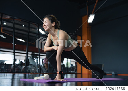 Woman, stretch and legs in gym, warm up and preparation for workout for fitness in health club. Flexibility, sports and loosen muscles for exercise on floor. 132013288