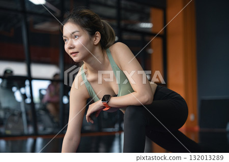 Woman, stretch and legs in gym, warm up and preparation for workout for fitness in health club. Flexibility, sports and loosen muscles for exercise on floor. Woman, stretch and legs in gym, warm up and preparation for workout for fitness in health club. Flexibility, sports and loosen muscles for exercise on floor. 132013289