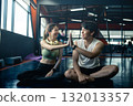 Happy young man and woman high five for success or good exercise and well done gesture for reaching fitness goal. Active trainer and client woman celebrating a great workout, training or exercising. 132013357