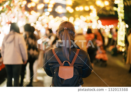 happy tourist woman stands on a German christmas market . Merry Christmas, holiday and happy New Year concept 132013388