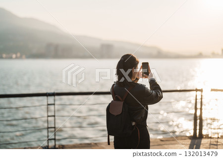 woman traveler traveling in Taiwan, female Tourist sightseeing at Tamsui Old Street in sunset. Popular landmark for tourists attractions in Taipei, Taiwan 132013479