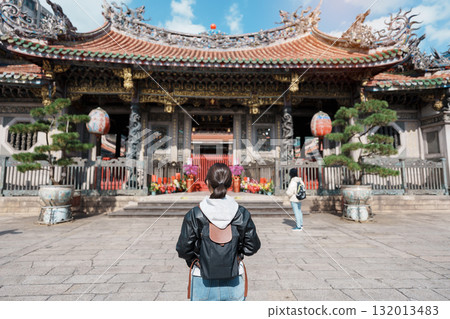 woman traveler visiting in Taiwan, female Tourist sightseeing at Longshan Temple, Chinese folk religious temple in Wanhua District, Taipei City. landmark and popular. Travel and Vacation concept 132013483