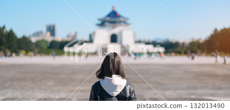woman traveler visiting in Taiwan, female Tourist sightseeing at National Chiang Kai shek Memorial or Hall Freedom Square, Taipei City. Popular landmark and attractions. Asia Travel concept 132013490