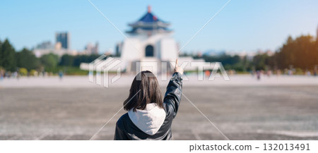 woman traveler visiting in Taiwan, female Tourist sightseeing at National Chiang Kai shek Memorial or Hall Freedom Square, Taipei City. Popular landmark and attractions. Asia Travel concept 132013491