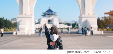 woman traveler visiting in Taiwan, female Tourist sightseeing at National Chiang Kai shek Memorial or Hall Freedom Square, Taipei City. Popular landmark and attractions. Asia Travel concept 132013496