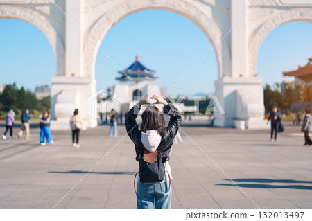 woman traveler visiting in Taiwan, female Tourist sightseeing at National Chiang Kai shek Memorial or Hall Freedom Square, Taipei City. Popular landmark and attractions. Asia Travel concept 132013497