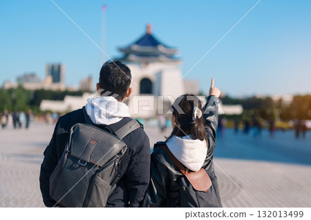 Couple traveler traveling in Taiwan, Tourists sightseeing at National Chiang Kai shek Memorial or Hall Freedom Square, Taipei City. Popular landmark and attractions. Asia Travel and vacation concept 132013499