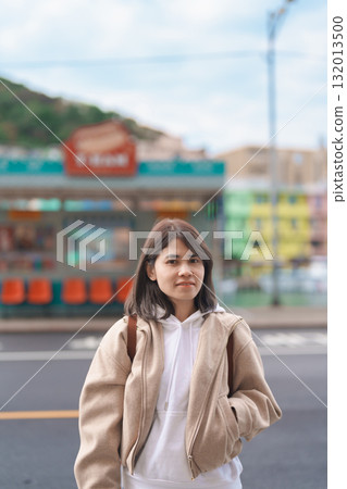 woman traveler visiting in Taiwan, female Tourist with backpack sightseeing at Keelung, Colorful Zhengbin Fishing Port. Popular landmarks and attractions near Taipei City.  Asia Travel concept 132013500