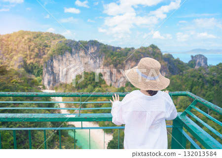 Woman tourist traveling in Krabi, Thailand. happy traveller enjoy and sightseeing view at koh Hong island viewpoint. summer trip, destination, Southeast Asia Travel, vacation and holiday concept Woman tourist traveling in Krabi, Thailand. happy traveller enjoy and sightseeing view at koh Hong island viewpoint. summer trip, destination, Southeast Asia Travel, vacation and holiday concept 132013584
