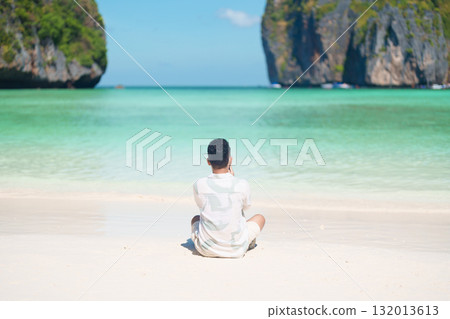 man tourist traveling and sightseeing in Krabi, Thailand, happy traveller enjoy at Maya Bay beach on Phi Phi island, Popular paradise island, destination, Southeast Asia Travel, vacation and holiday man tourist traveling and sightseeing in Krabi, Thailand, happy traveller enjoy at Maya Bay beach on Phi Phi island, Popular paradise island, destination, Southeast Asia Travel, vacation and holiday 132013613