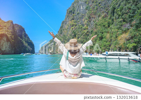 Woman tourist on boat trip, happy traveller relaxing at Pileh lagoon on Phi Phi island, Krabi, Thailand. Exotic landmark, destination Southeast Asia Travel, summer vacation and holiday concept 132013618