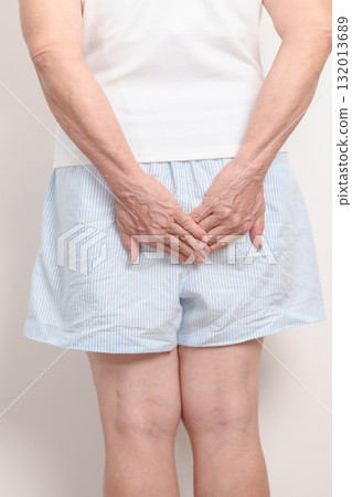 elderly Woman having Anal symptoms pain for Hemorrhoids disease, Constipation, Anal cancer awareness month, diarrhea, Irritable Bowel Syndrome, IBS, Inflammation, Colorectal cancer and Anal Procttis 132013689