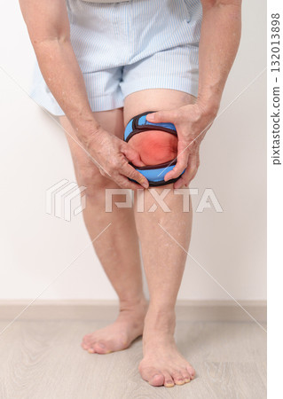 Elderly woman having knee ache with knee support brace for concepts of Runners Knee or Patellofemoral Pain Syndrome, osteoarthritis, arthritis, rheumatism and Patellar Tendinitis. Senior health care Elderly woman having knee ache with knee support brace for concepts of Runners Knee or Patellofemoral Pain Syndrome, osteoarthritis, arthritis, rheumatism and Patellar Tendinitis. Senior health care 132013898