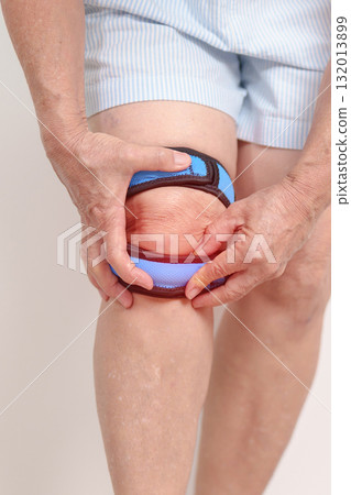 Elderly woman having knee ache with knee support brace for concepts of Runners Knee or Patellofemoral Pain Syndrome, osteoarthritis, arthritis, rheumatism and Patellar Tendinitis. Senior health care Elderly woman having knee ache with knee support brace for concepts of Runners Knee or Patellofemoral Pain Syndrome, osteoarthritis, arthritis, rheumatism and Patellar Tendinitis. Senior health care 132013899