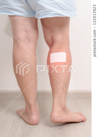 Elderly woman having Calf pain with Medicated pain relief patch plaster for concepts of Calf Muscle Strain, muscle pull, Leg Cramp, Sprain, aches, Varicose Veins, Deep Vein and world Thrombosis day Elderly woman having Calf pain with Medicated pain relief patch plaster for concepts of Calf Muscle Strain, muscle pull, Leg Cramp, Sprain, aches, Varicose Veins, Deep Vein and world Thrombosis day 132013923